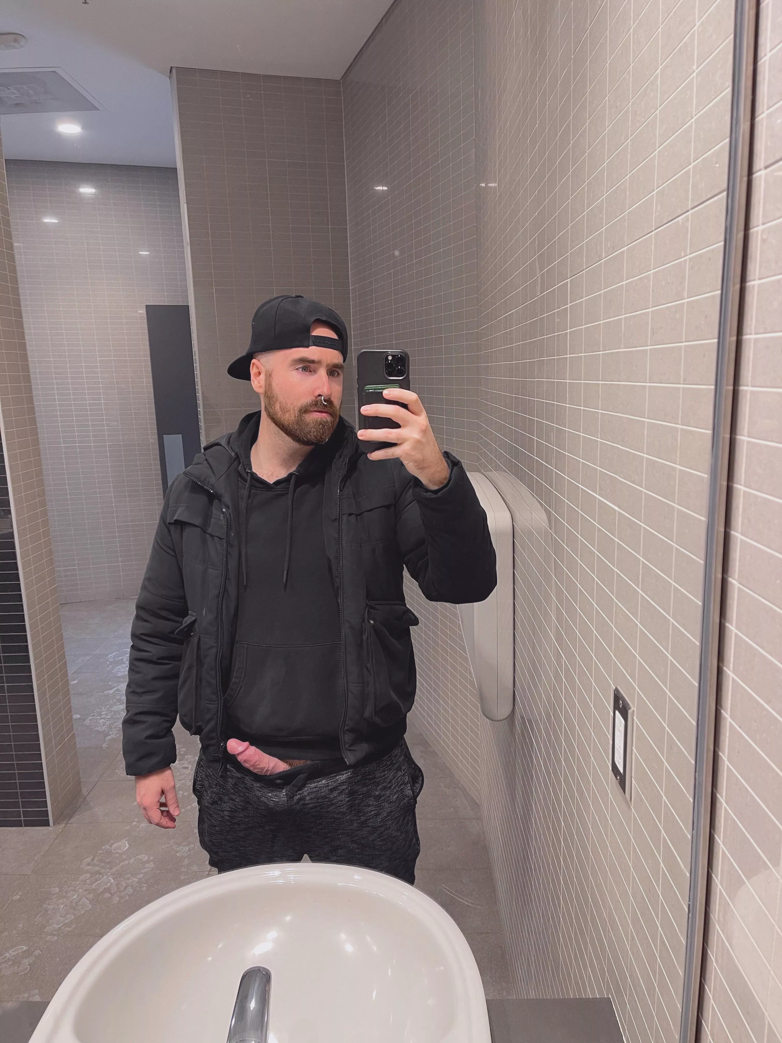 In a public washroom waiting for someone to suck my dick