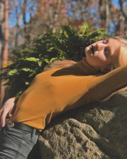 Sexy, classy, & casually laying on a boulder