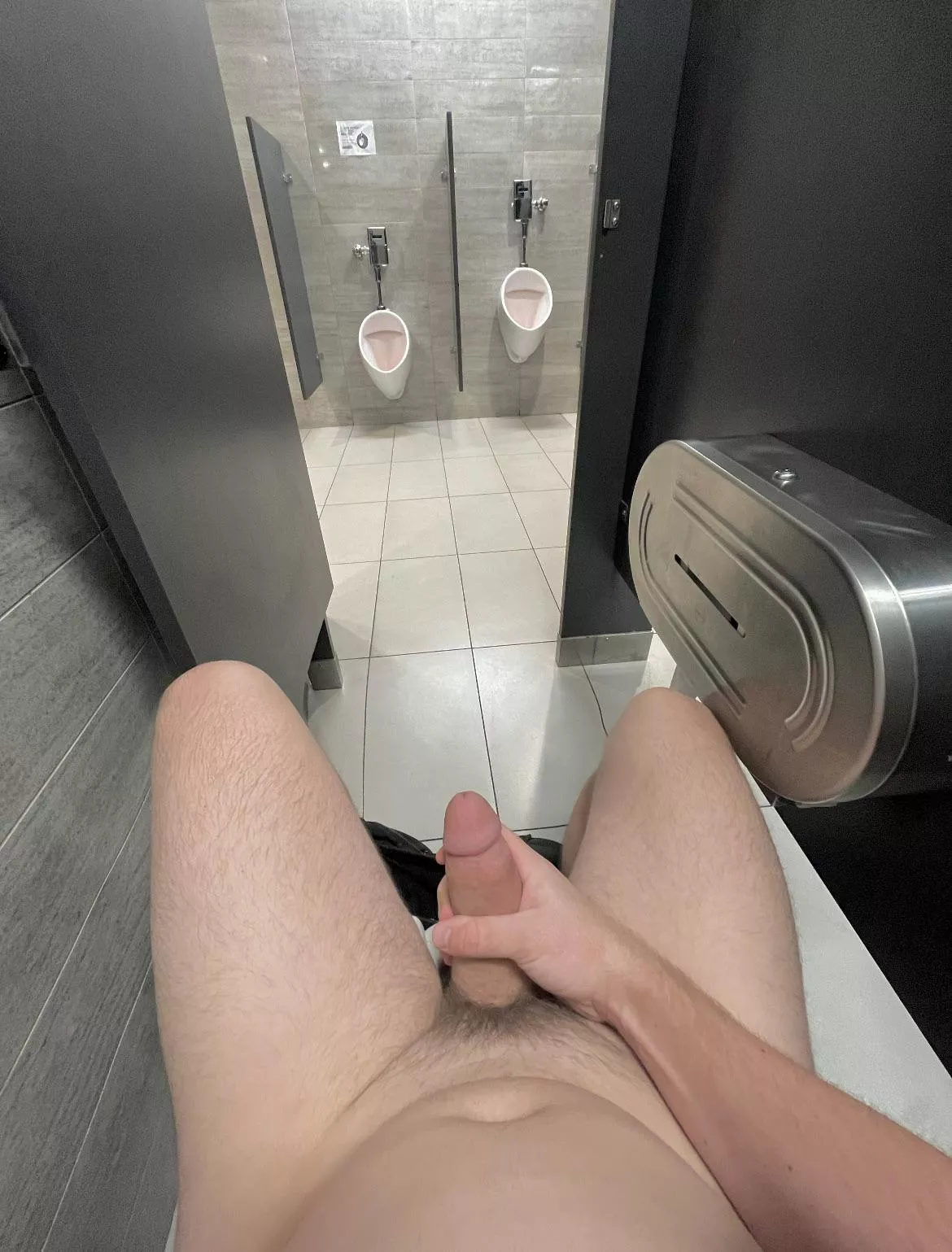 Fully naked and hard in the stall with the door wide open. A janitor walked by with a mop about a minute after this pic.