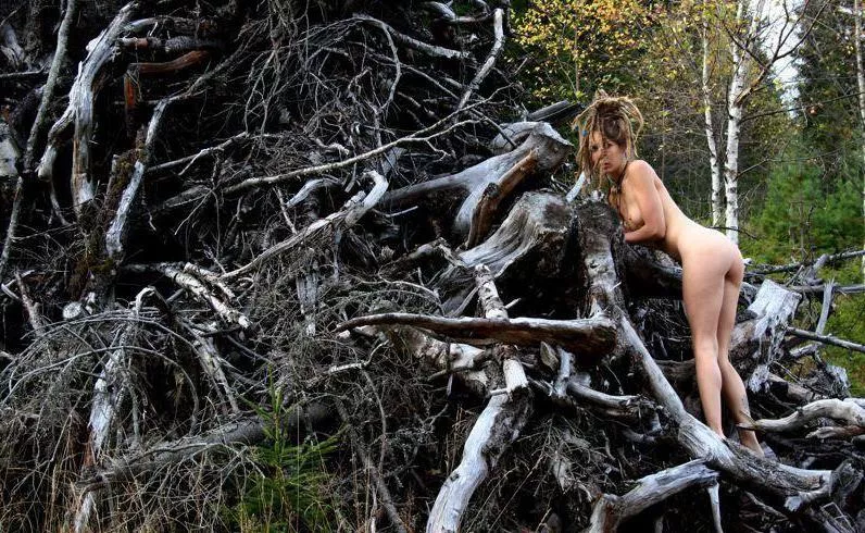 Leona, dreadlocked hippie chick exploring a clear cut!