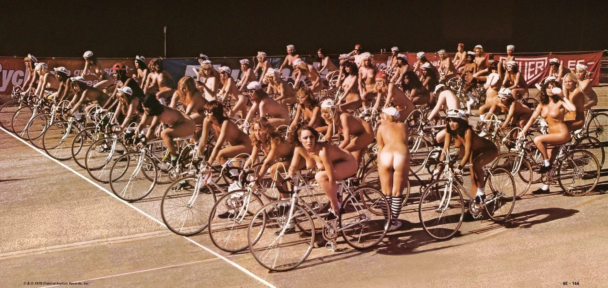 Back in 1978, at the Wimbledon Greyhound Stadium, 65 nude women rode their bikes to make a poster and video for 