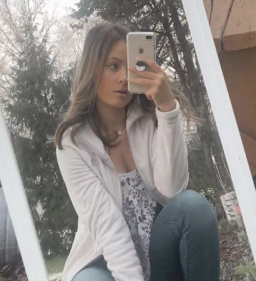 Pretty girl looking at something on her phone.