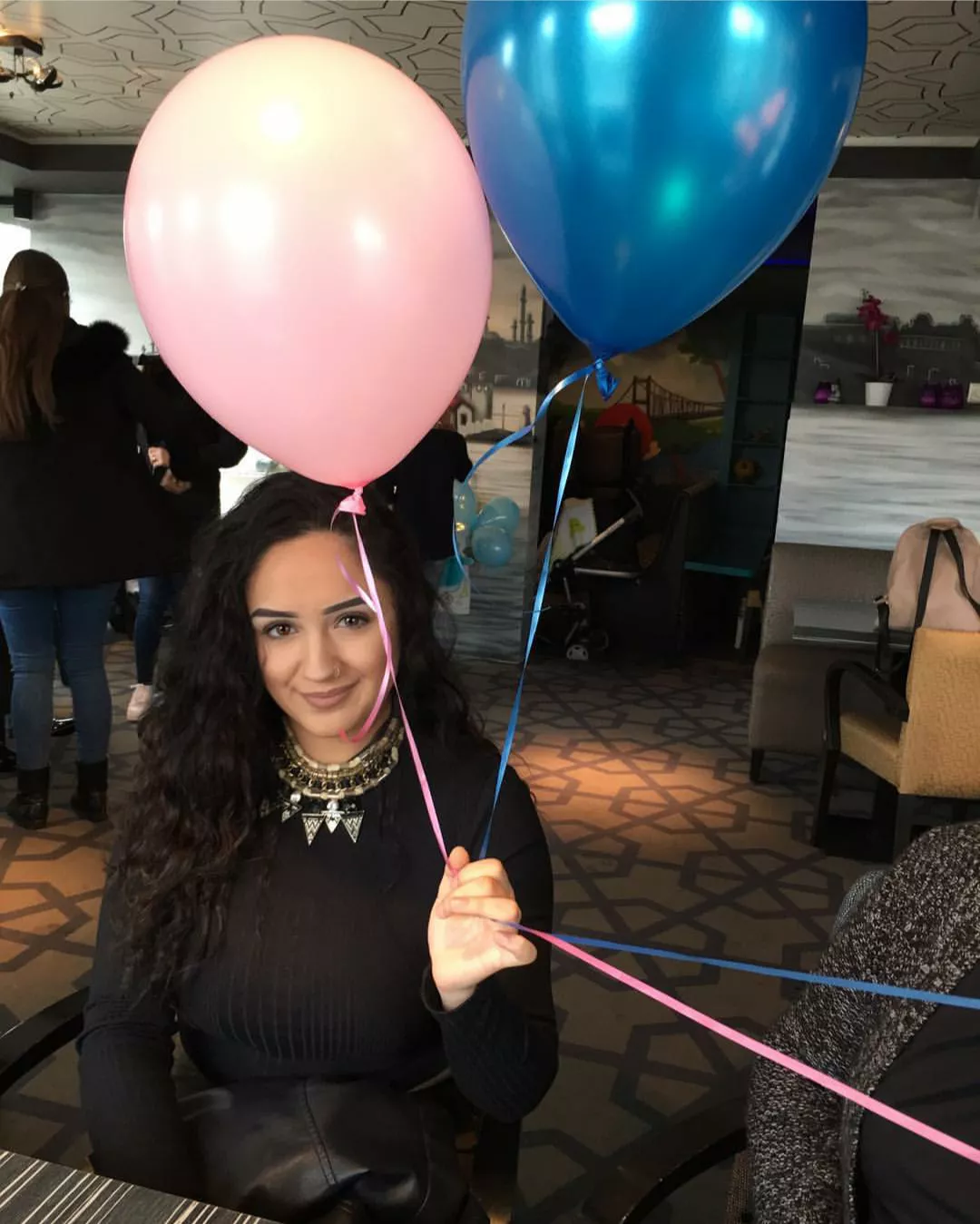 The balloons in her hand are not the only big things