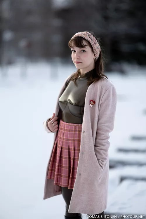 A translucent neck-entry catsuit underneath a jacket in winter