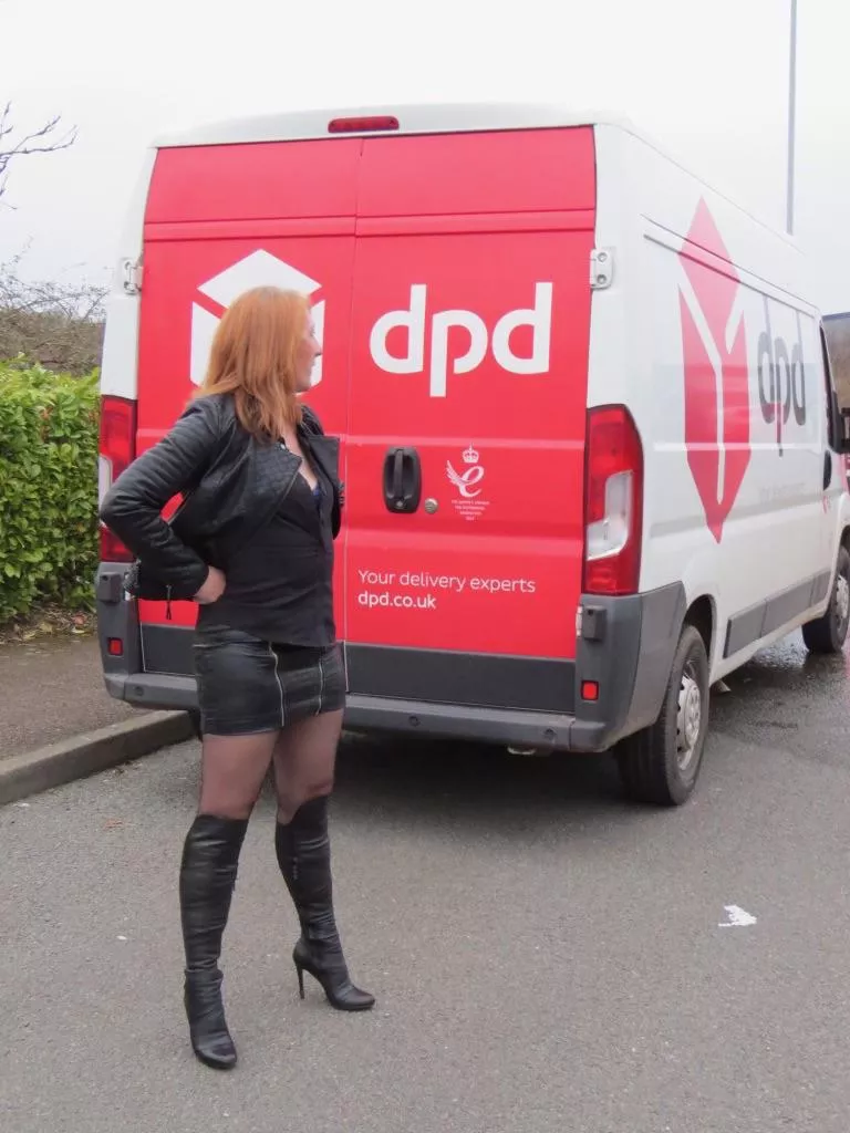 Redhead, Leather, stockings, boots on the street beside a DPD van - what could be better?