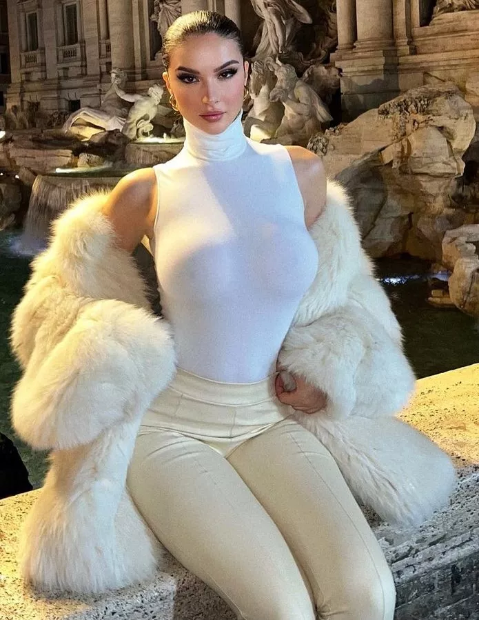 Looking classy while showing off her tits as much as possible, like a true trophy wife