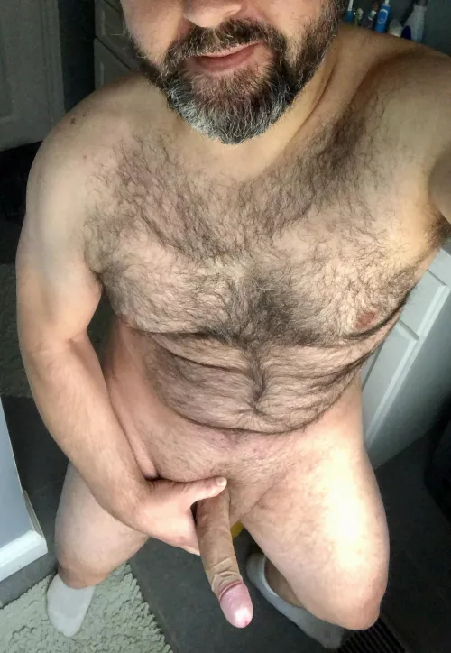Burly, bearded, and also bi, with a big, thick boner nestled between each thigh.