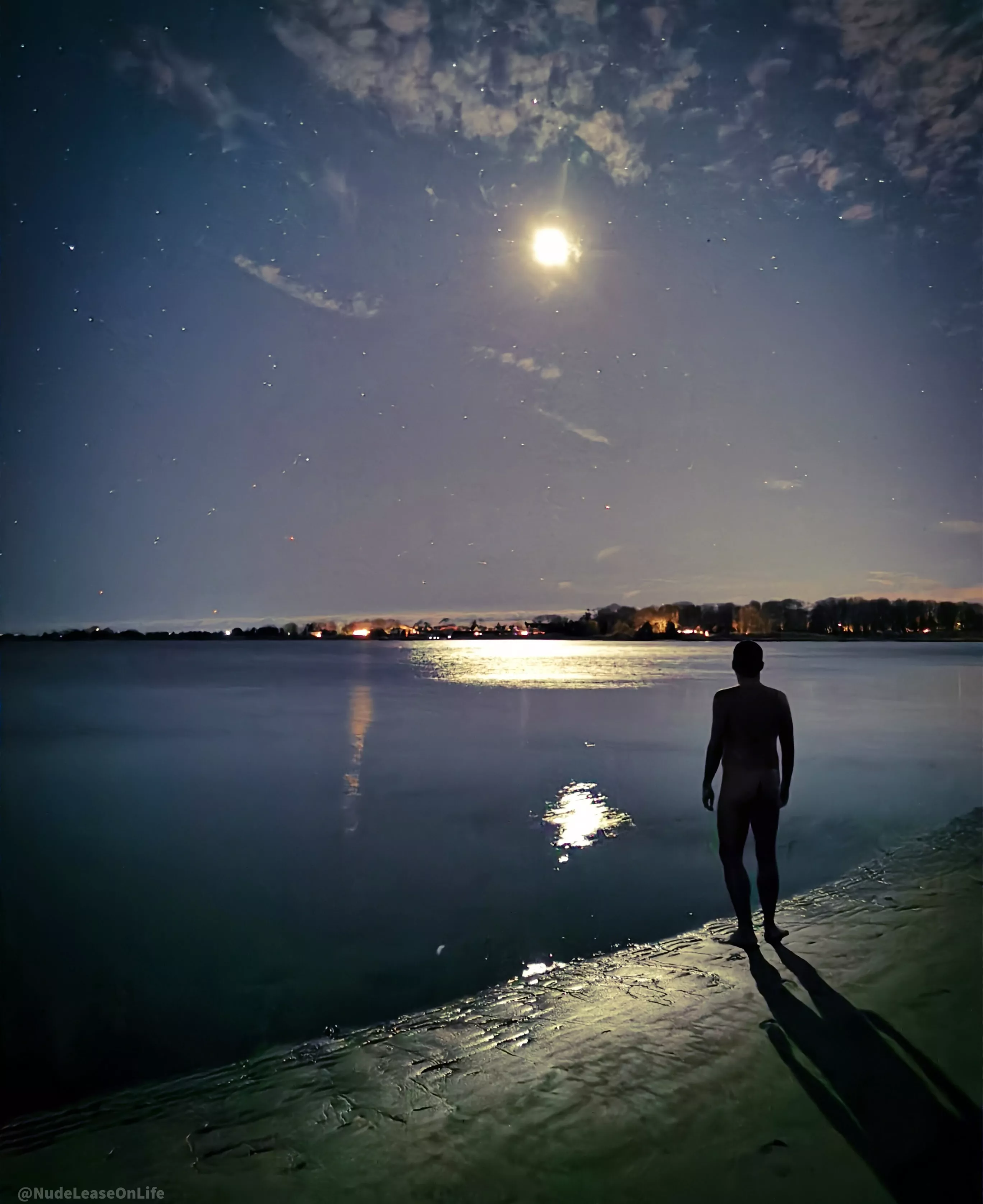 A mostly clear sky on a moonlit winter night by the bay. 🌝