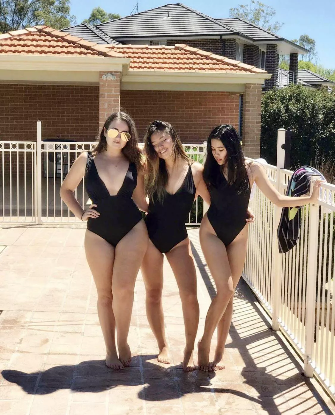 mixed trio in black swimsuits