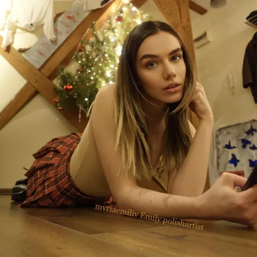 Laying on the floor in schoolgirl skirt, heels and transparent shirt