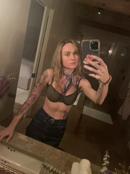 Brie Larson with temporary tattoos and a see through bra