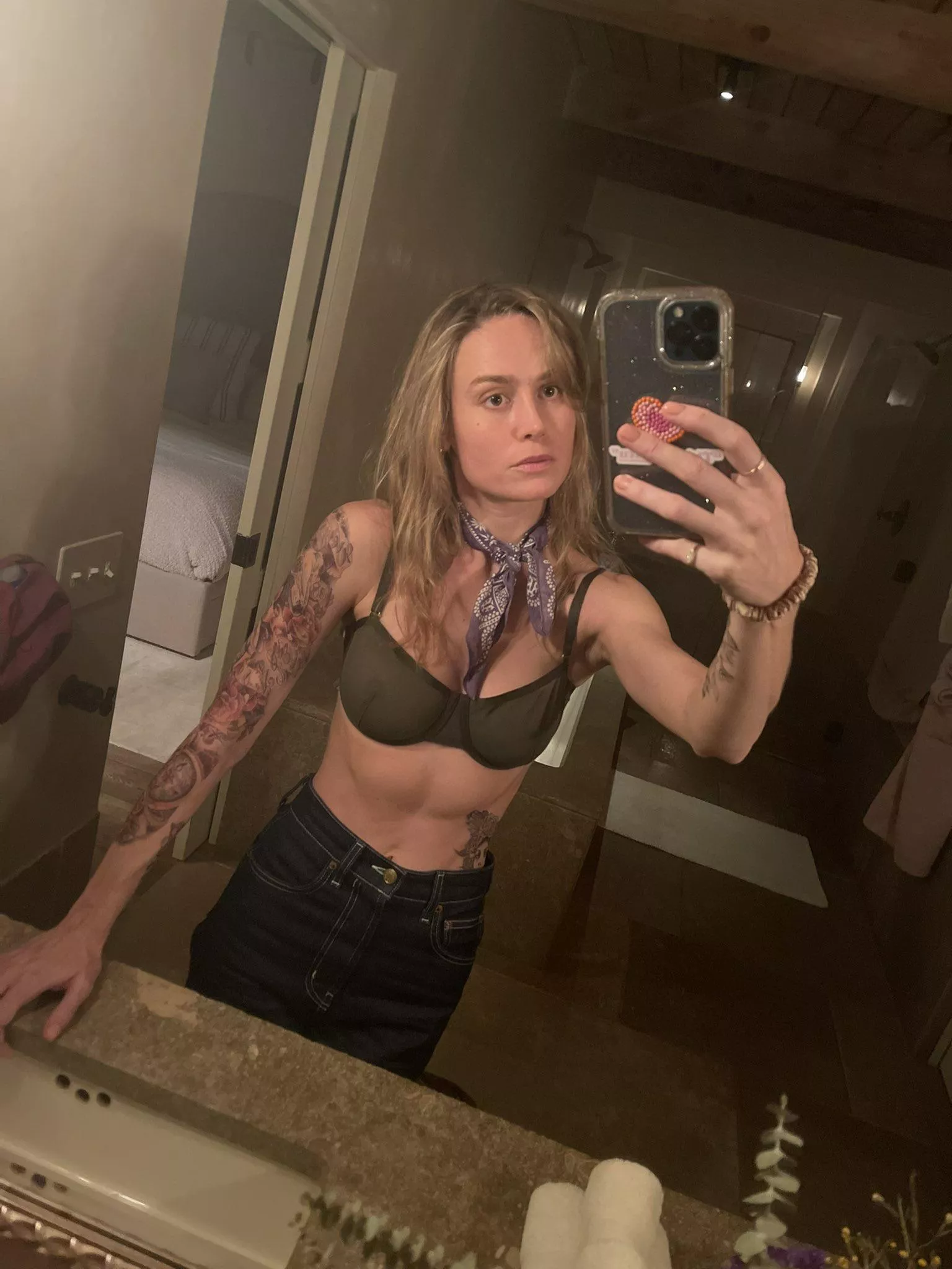 Brie Larson with temporary tattoos and a see through bra