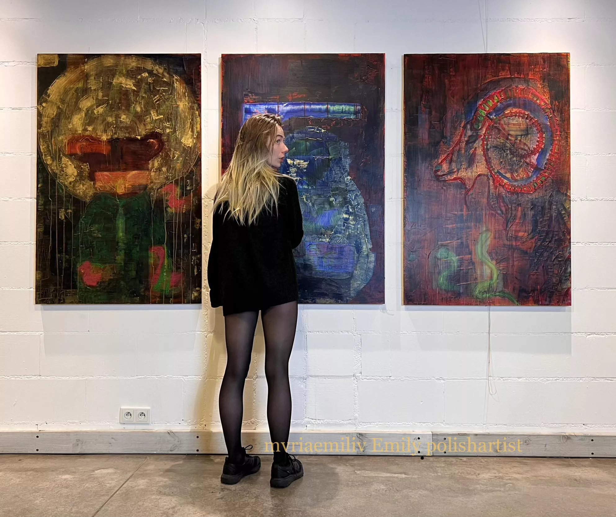 Just in sweater and tights next to my paintings