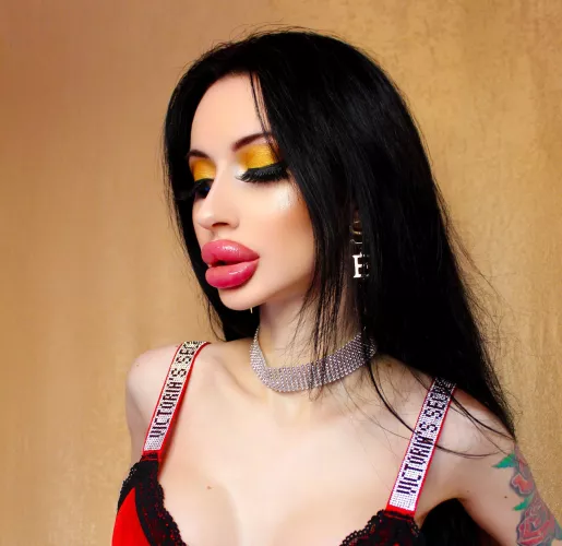 Doll with big lips in a red top