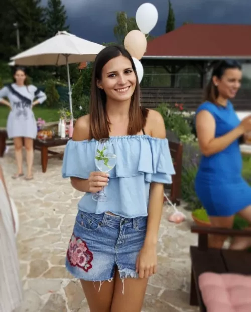 A pretty girl with a light summer cocktail