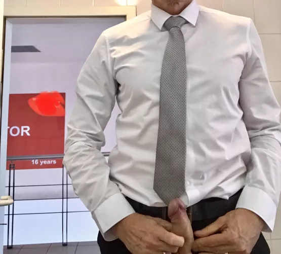 Visiting a client for a business meeting today. Standing in front of the mirror in the washroom with my dick out. Door to corridor is wide open behind me so anyone walking past would see everything in the mirror.