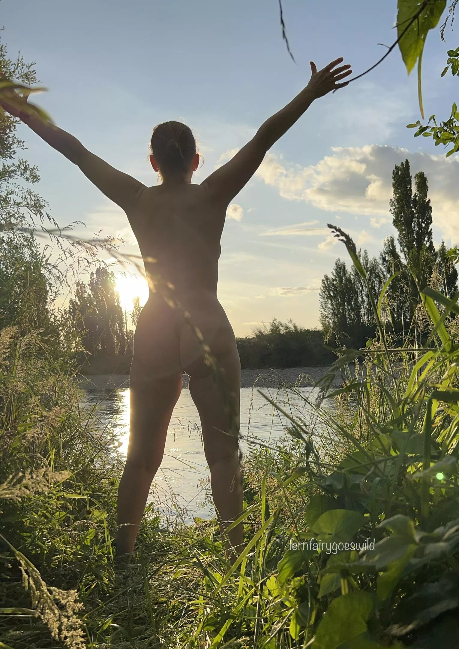 Nudist enjoying a beautiful evening by the river