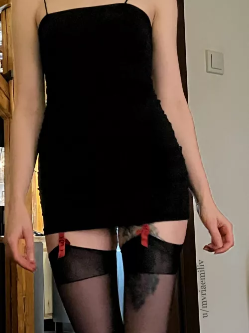 I really like this picture of super tight dress and stockings with visible red ribbons from suspender