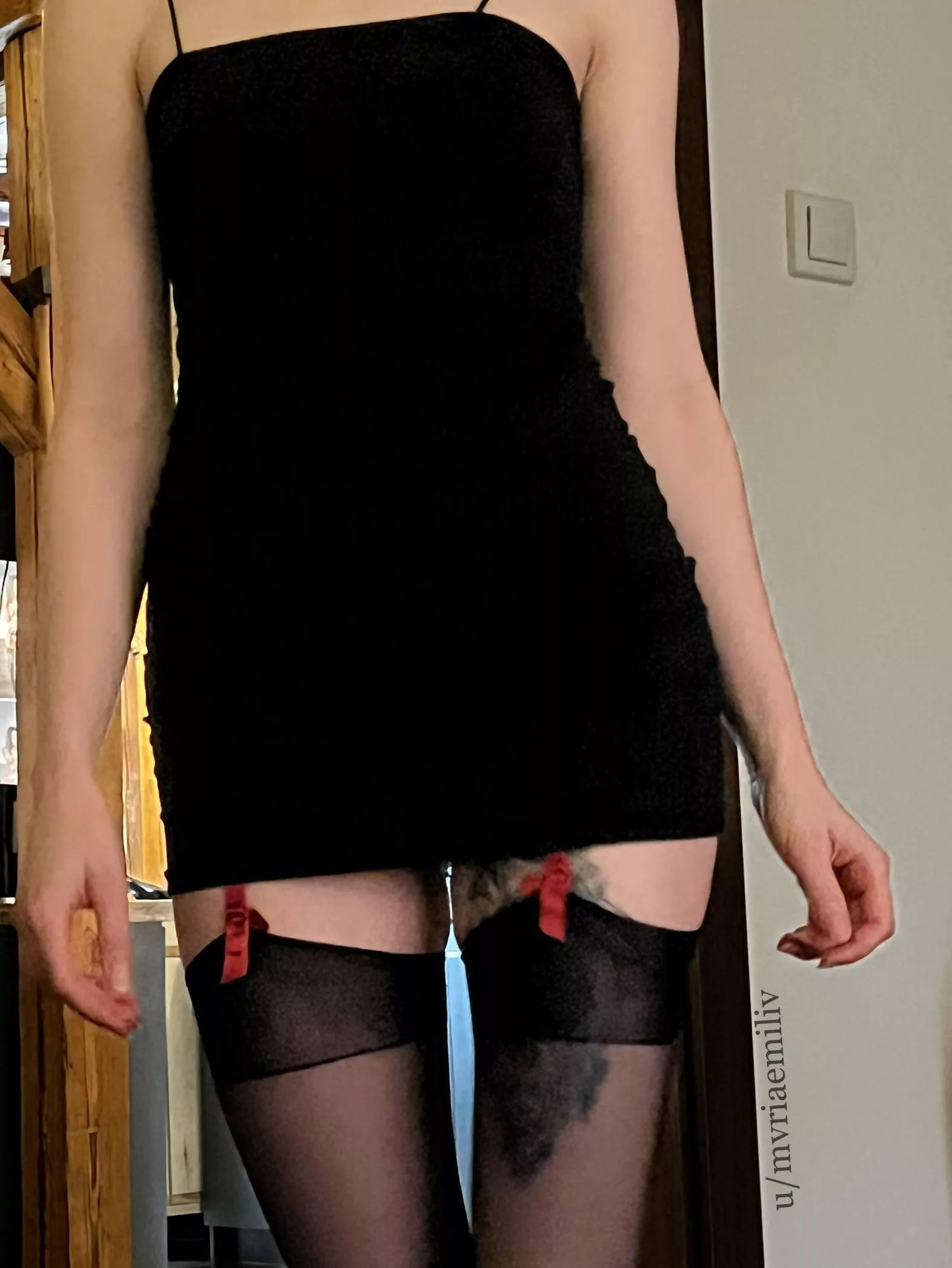 I really like this picture of super tight dress and stockings with visible red ribbons from suspender