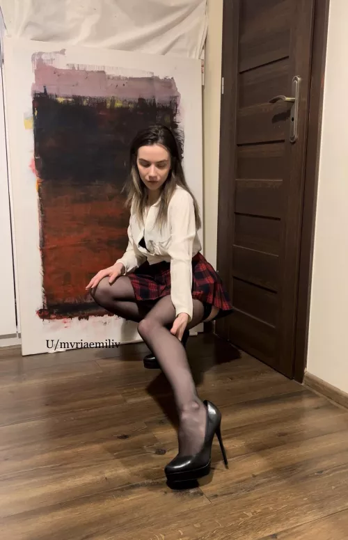 White shirt, schoolgirl skirt, nylons, heels and nicely exposed leg.