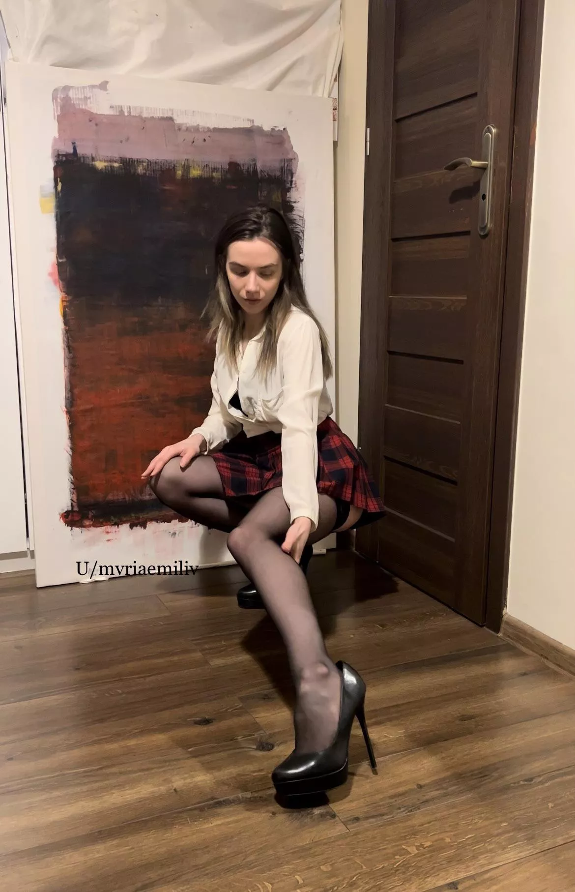 White shirt, schoolgirl skirt, nylons, heels and nicely exposed leg.