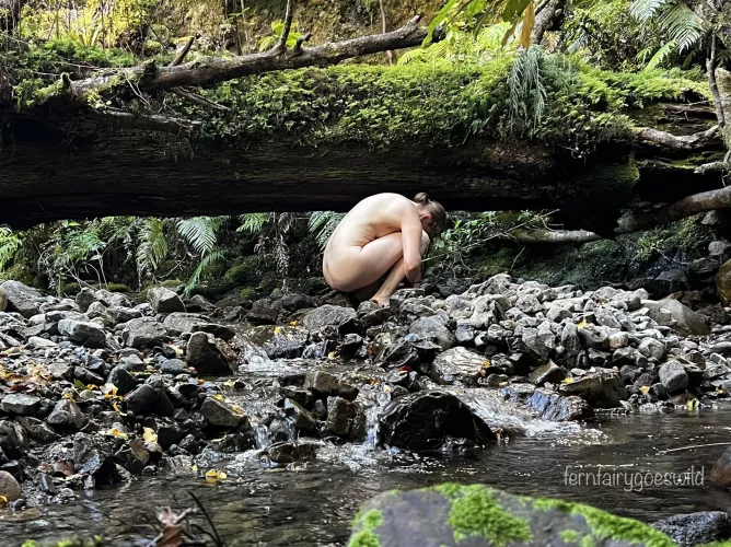 Nymph by a stream in a magical valley