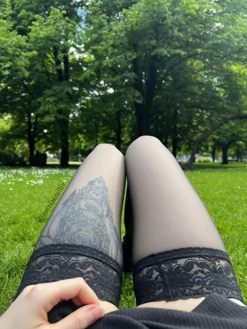 Legs in stockings while laying on the grass in park