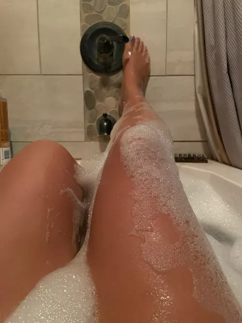 Nothing between these tan, long legs but bubbles.
