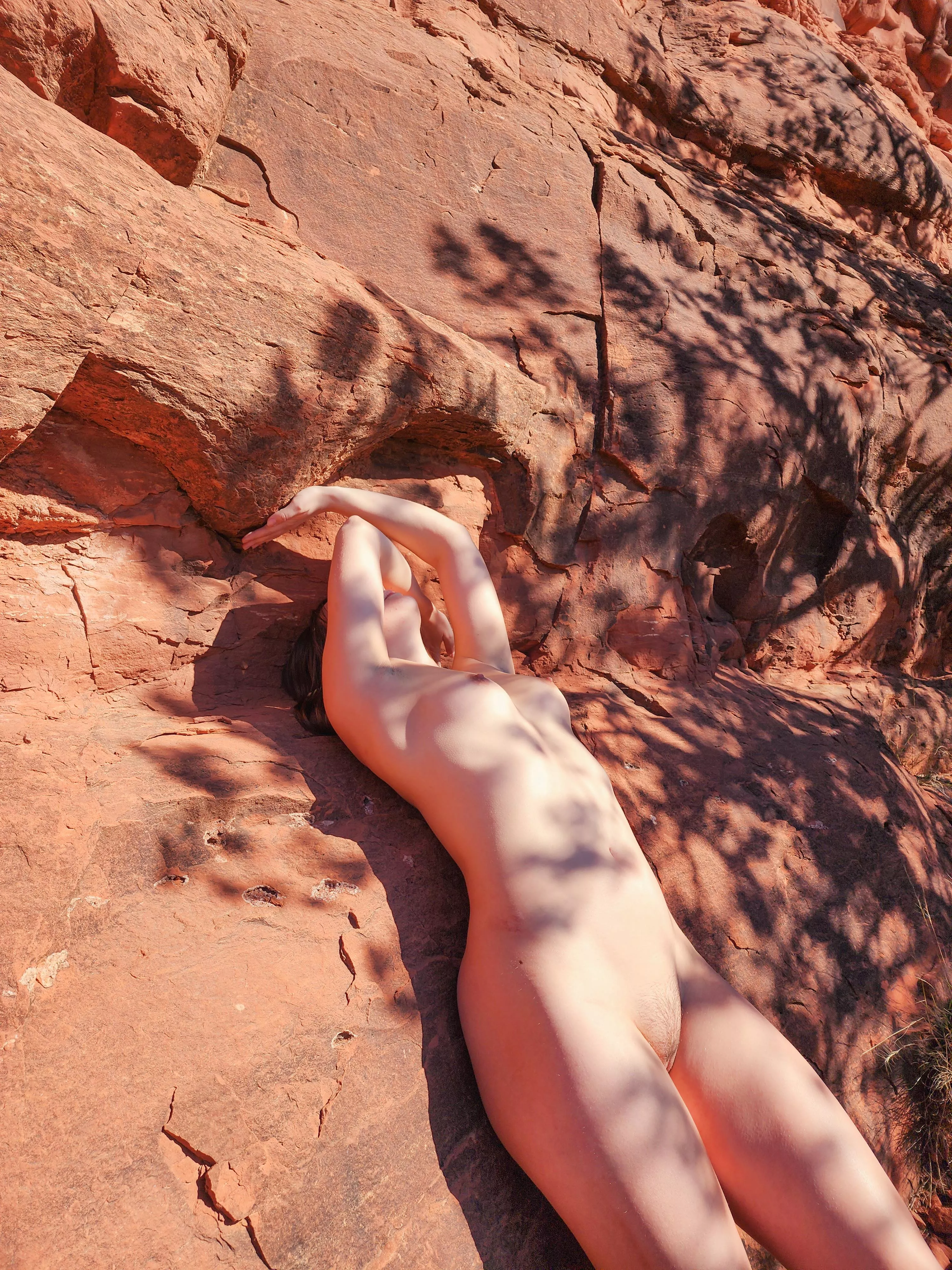 Skin against rock, natural yet molded by force