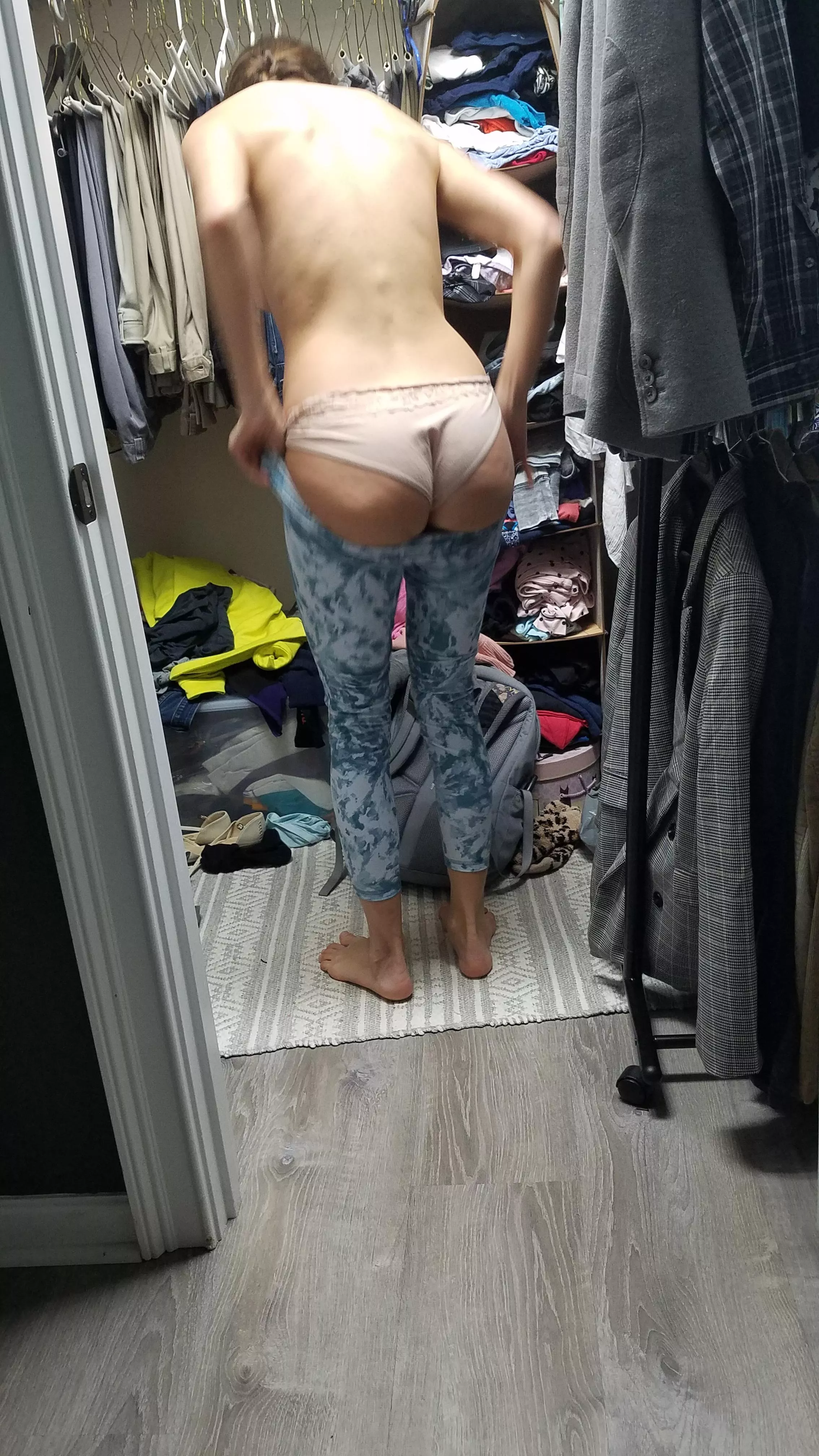 Trying to fit it in her gym pants