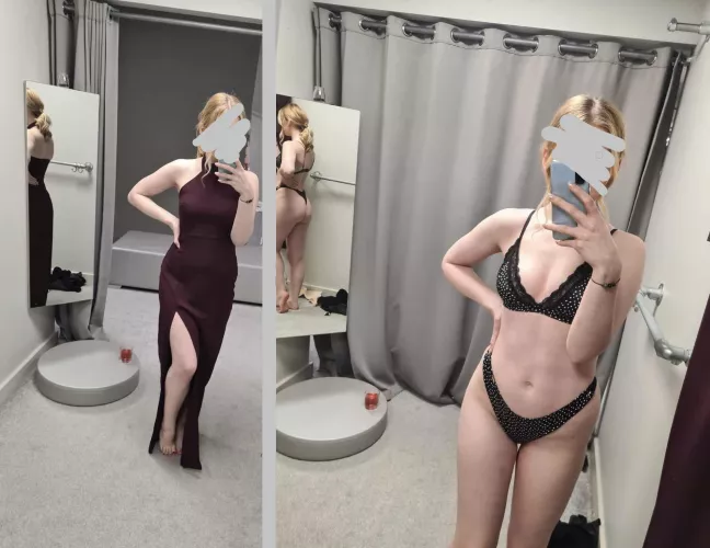 A petite girl trying on a dress