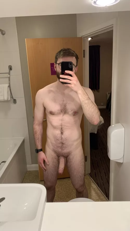 A neutral pose from a hotel mirror