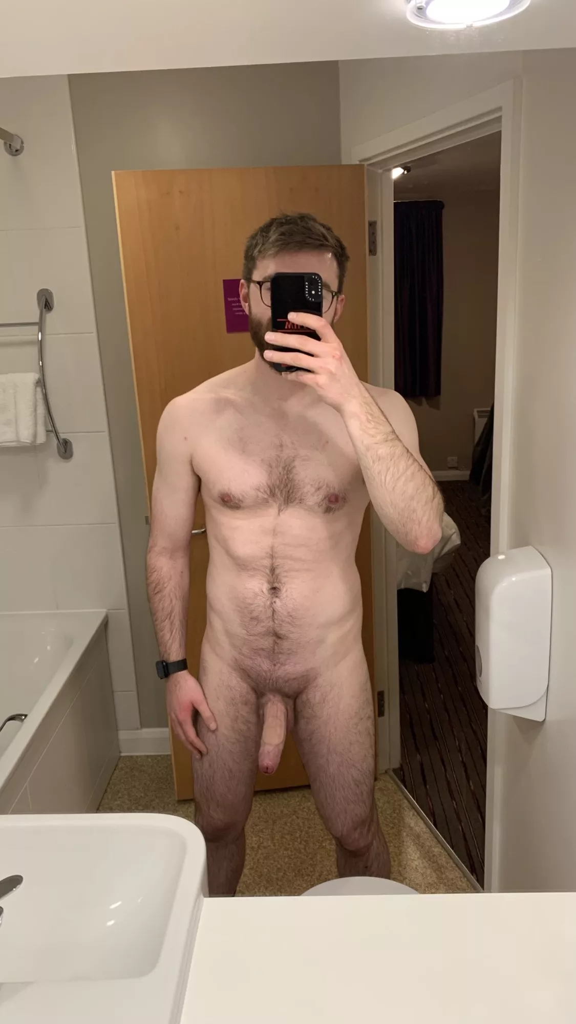 A neutral pose from a hotel mirror