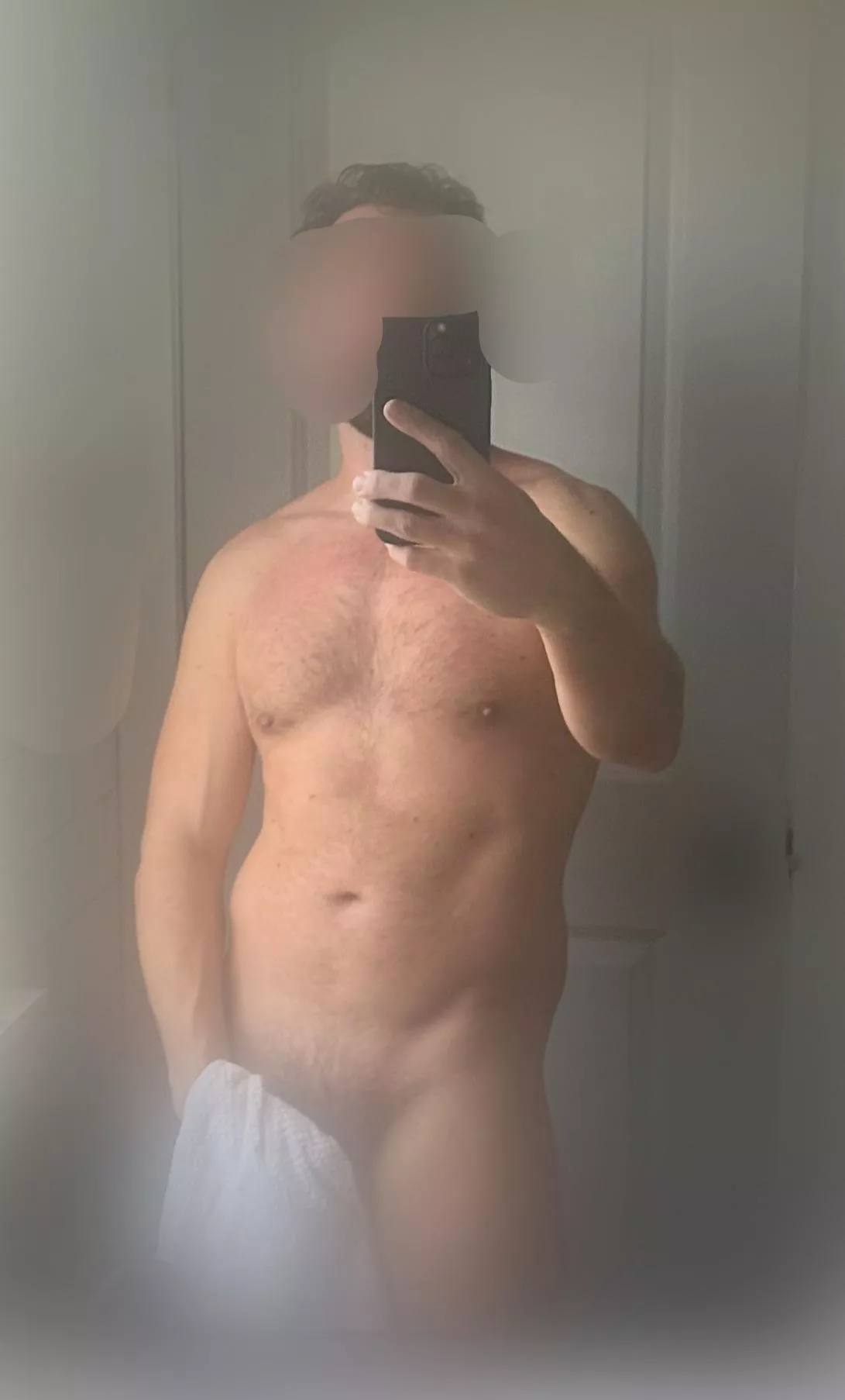 Body shot while shower steams up the bathroom