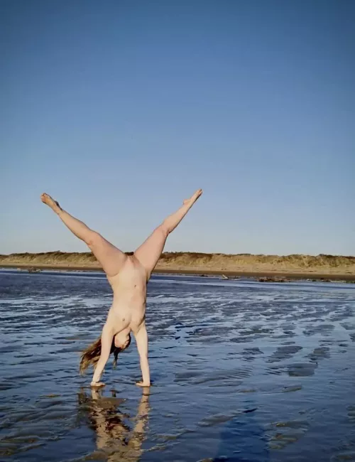 My wife, naked cartwheeling at the local beach