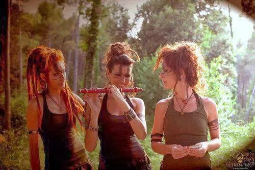 Red Dreadlocked flute players in the woods