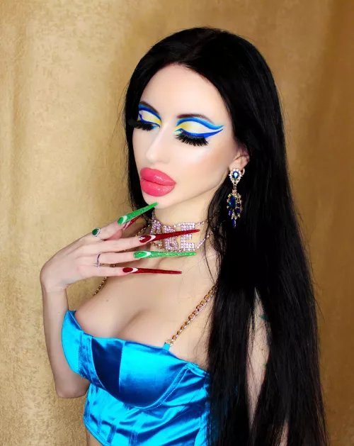 Bright blue makeup with big lips and long nails