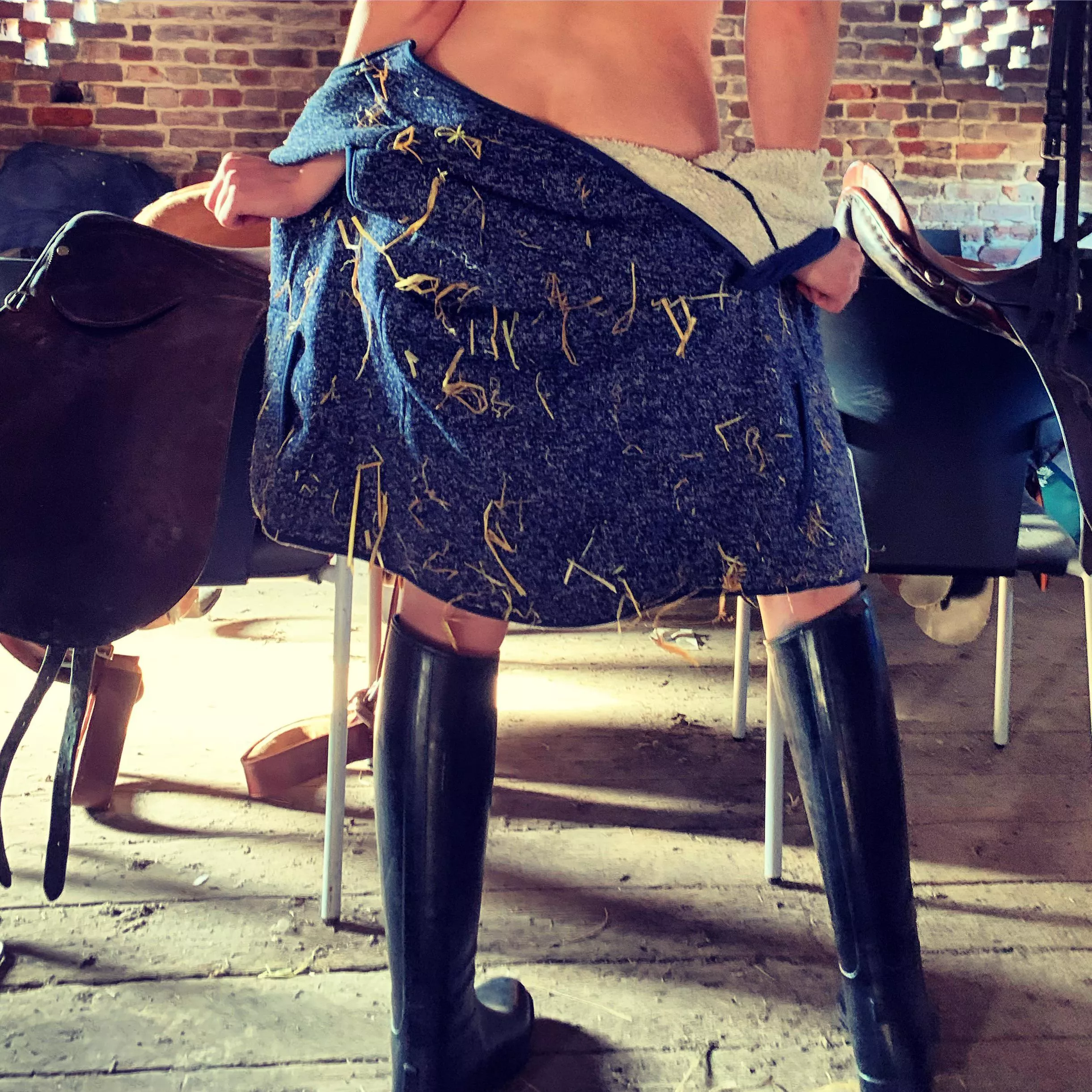 Rubber riding boots and not much else