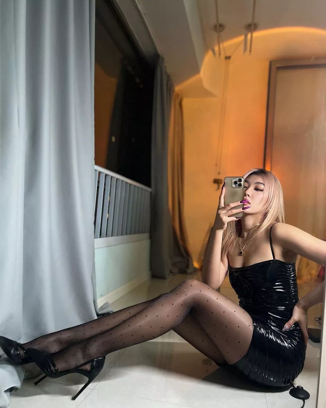 Shiny black dress and polka dot tights