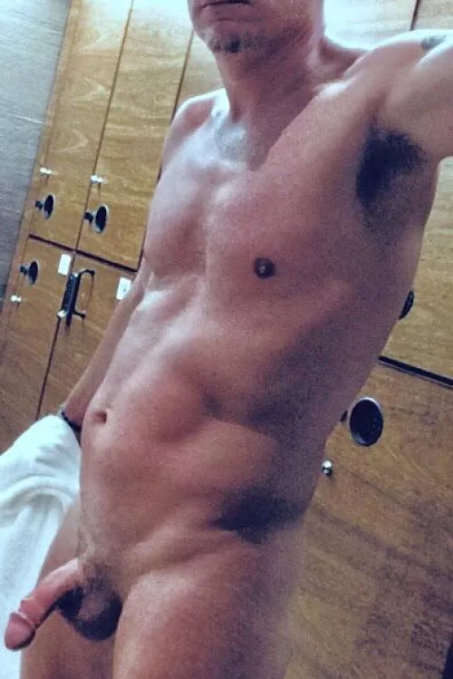 Me pulling towel away starting to get wood for pic in locker room.