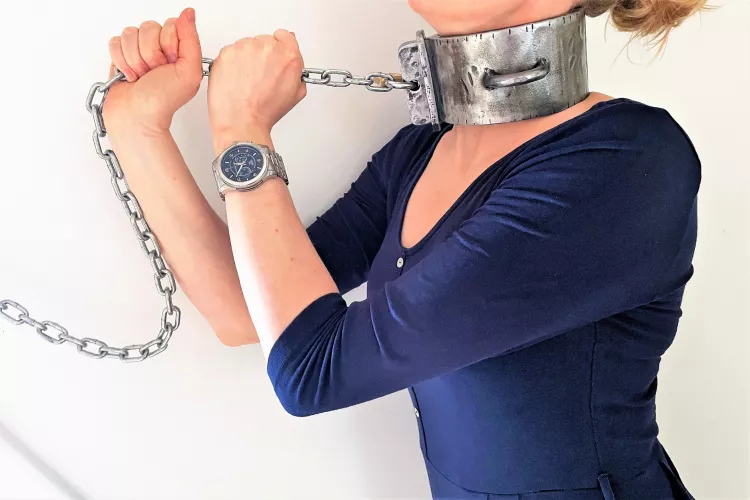 Collared to the wall. Several pounds of steel around my neck - and I love it