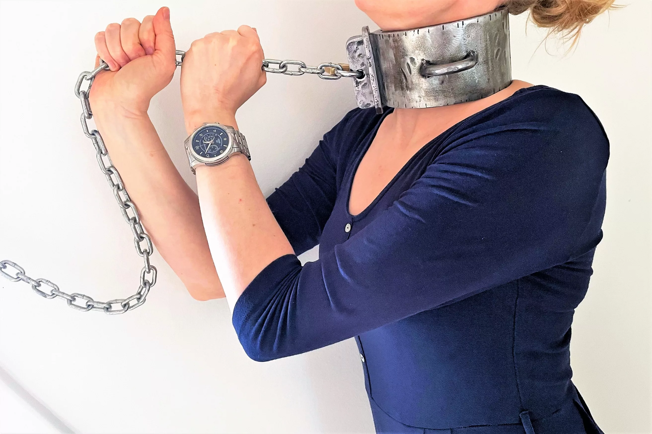 Collared to the wall. Several pounds of steel around my neck - and I love it