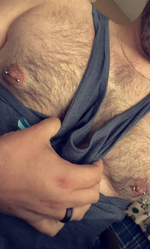 Hairy chest and nipple piercings