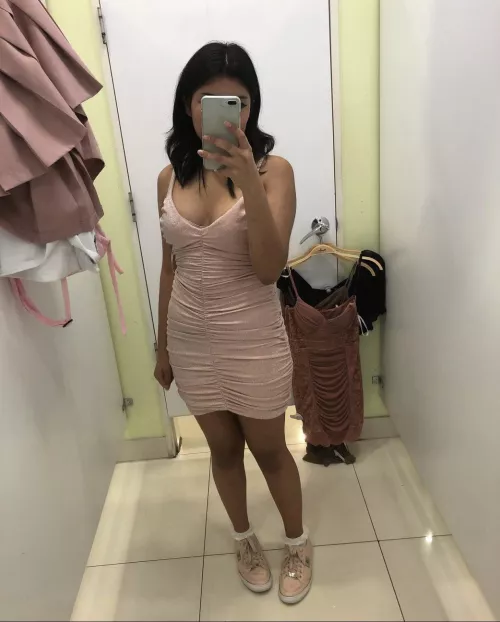 Is that a bra showing out of her dress and why?