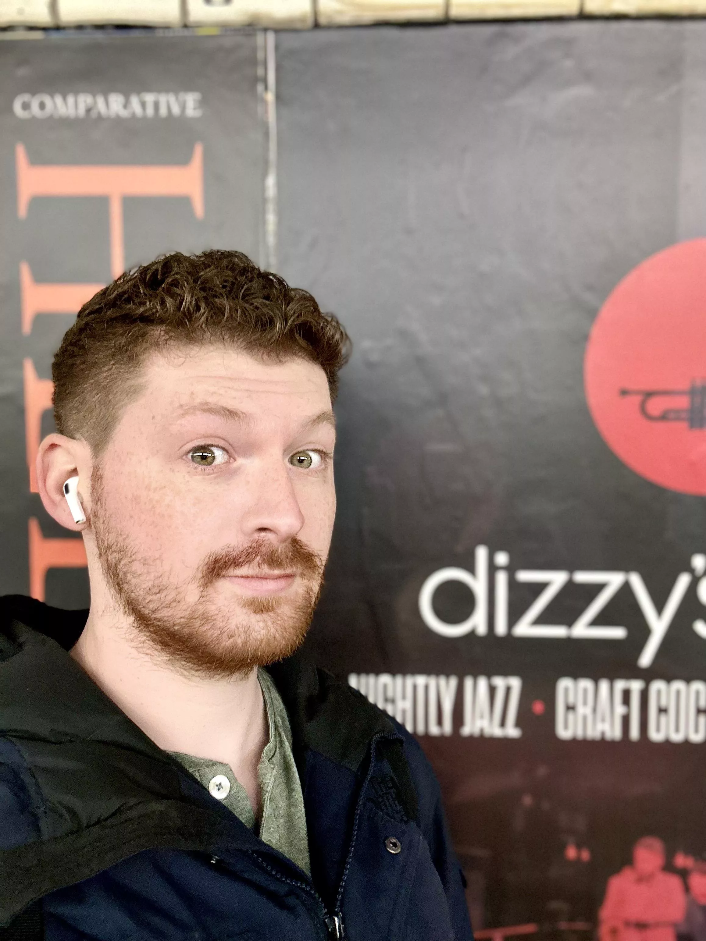 Latest Haircut in front of a sign that describes me all weekend