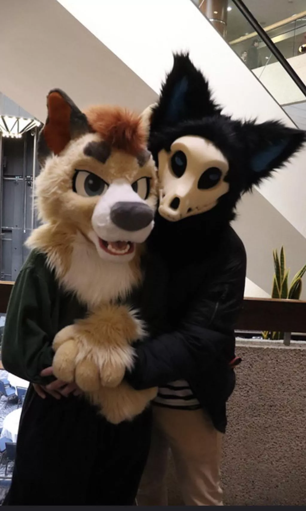 Me and my partner at a con after I converted him to become a furry