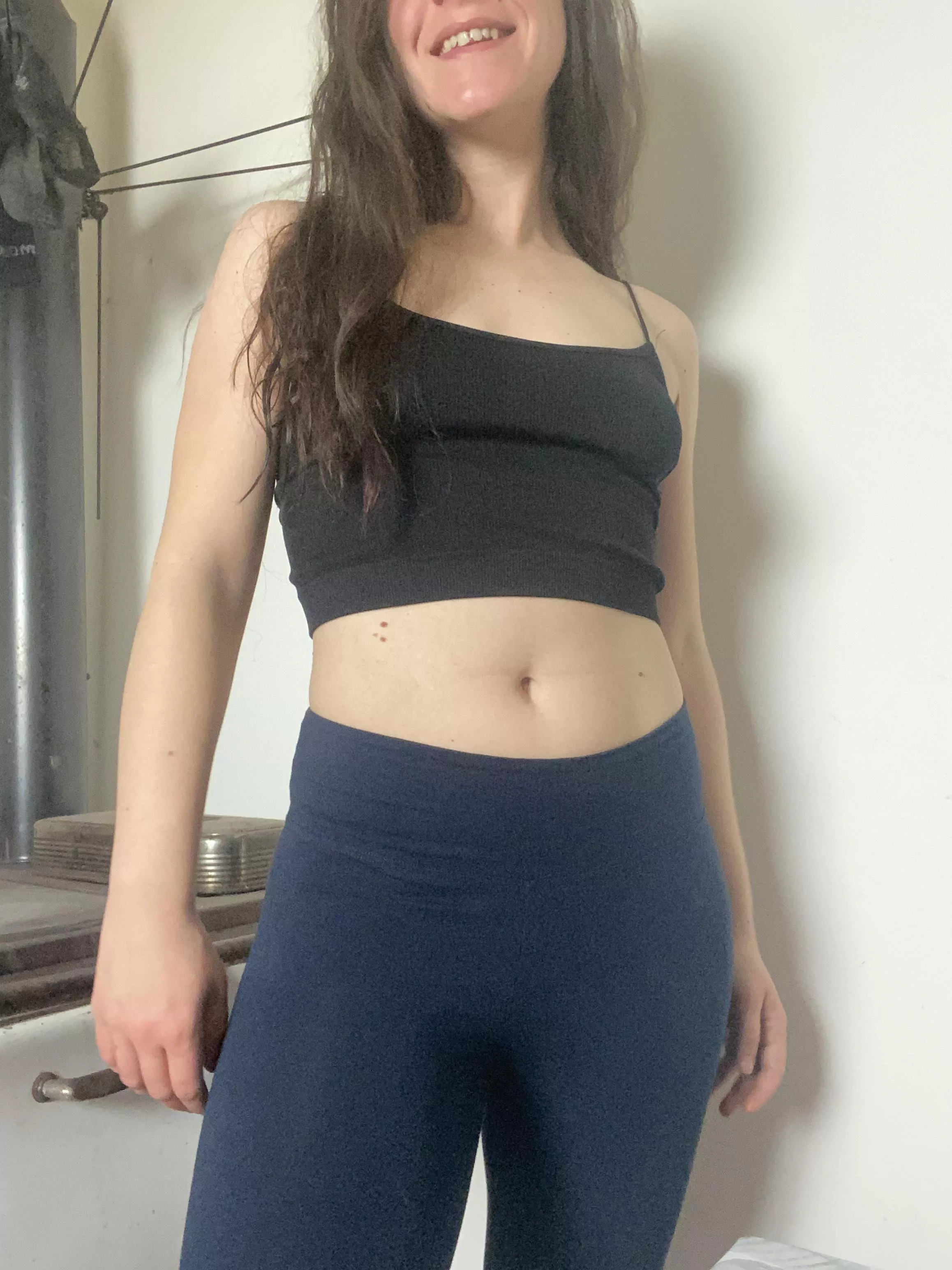 Smiling and looking cute while warming my butt on the stove