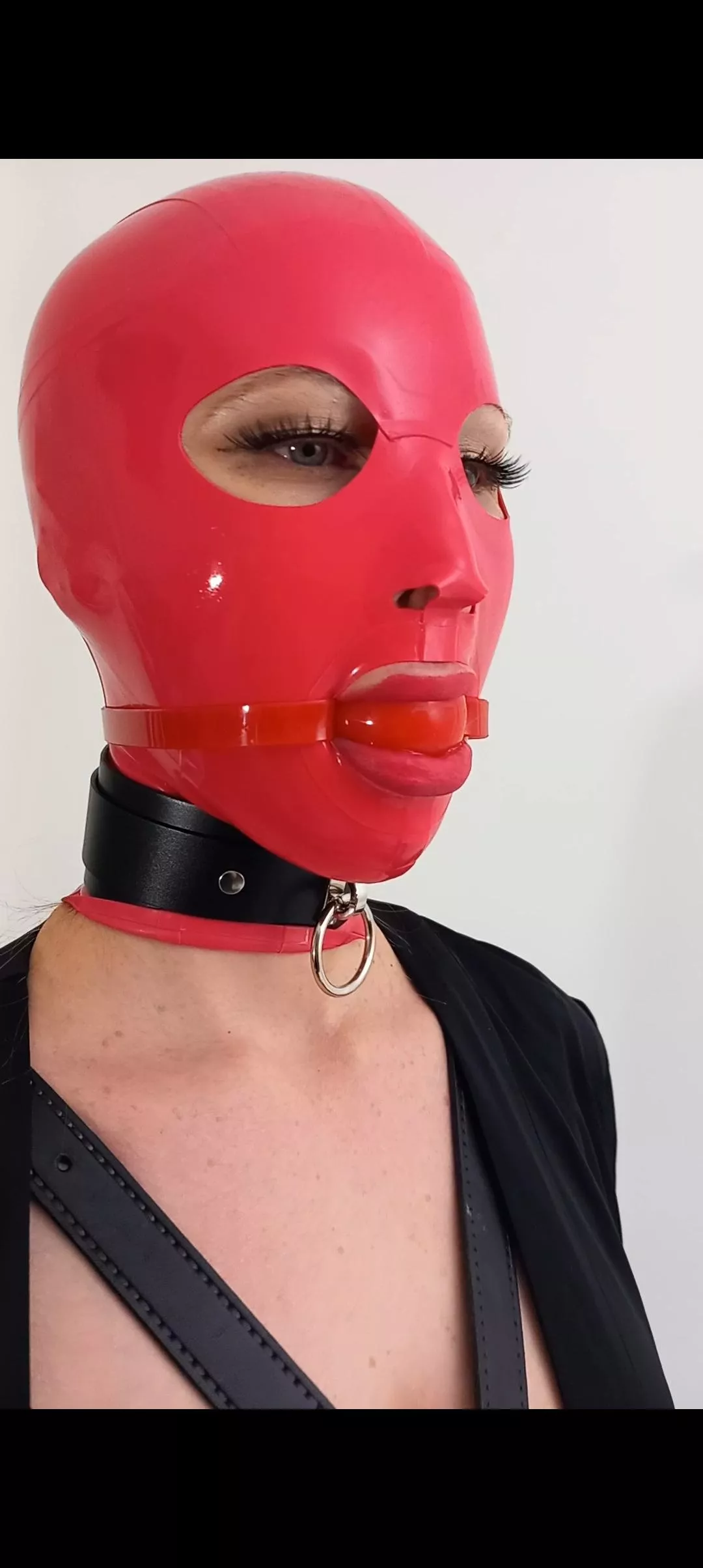 Pink latex hood and red ball gag