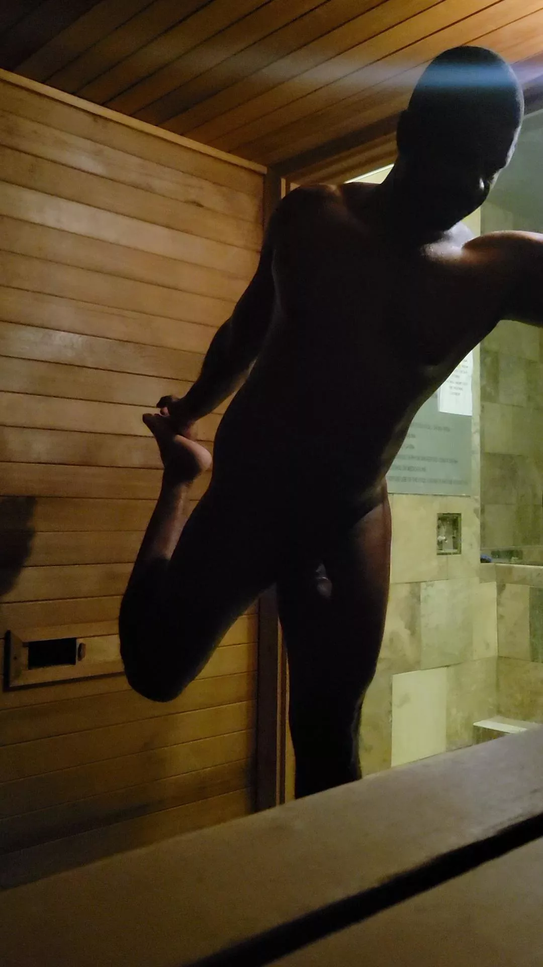 Stretching out in the sauna after a hard workout.