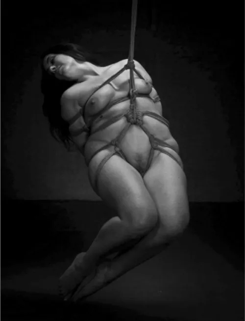 Her curvy body looks epic suspended in rope